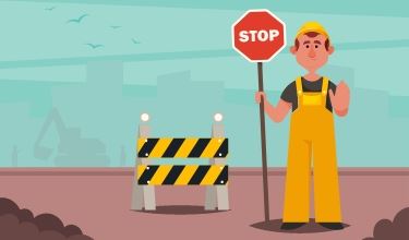 Road construction worker holding stop sign